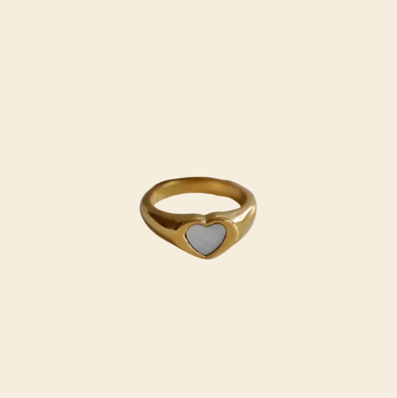 Gold ring on a white dish with a black background
