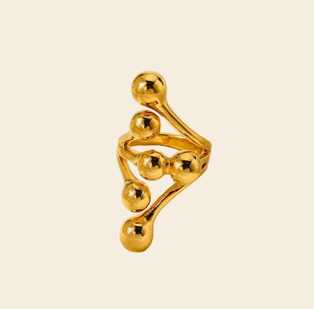 Gold ring with a unique design on a white background