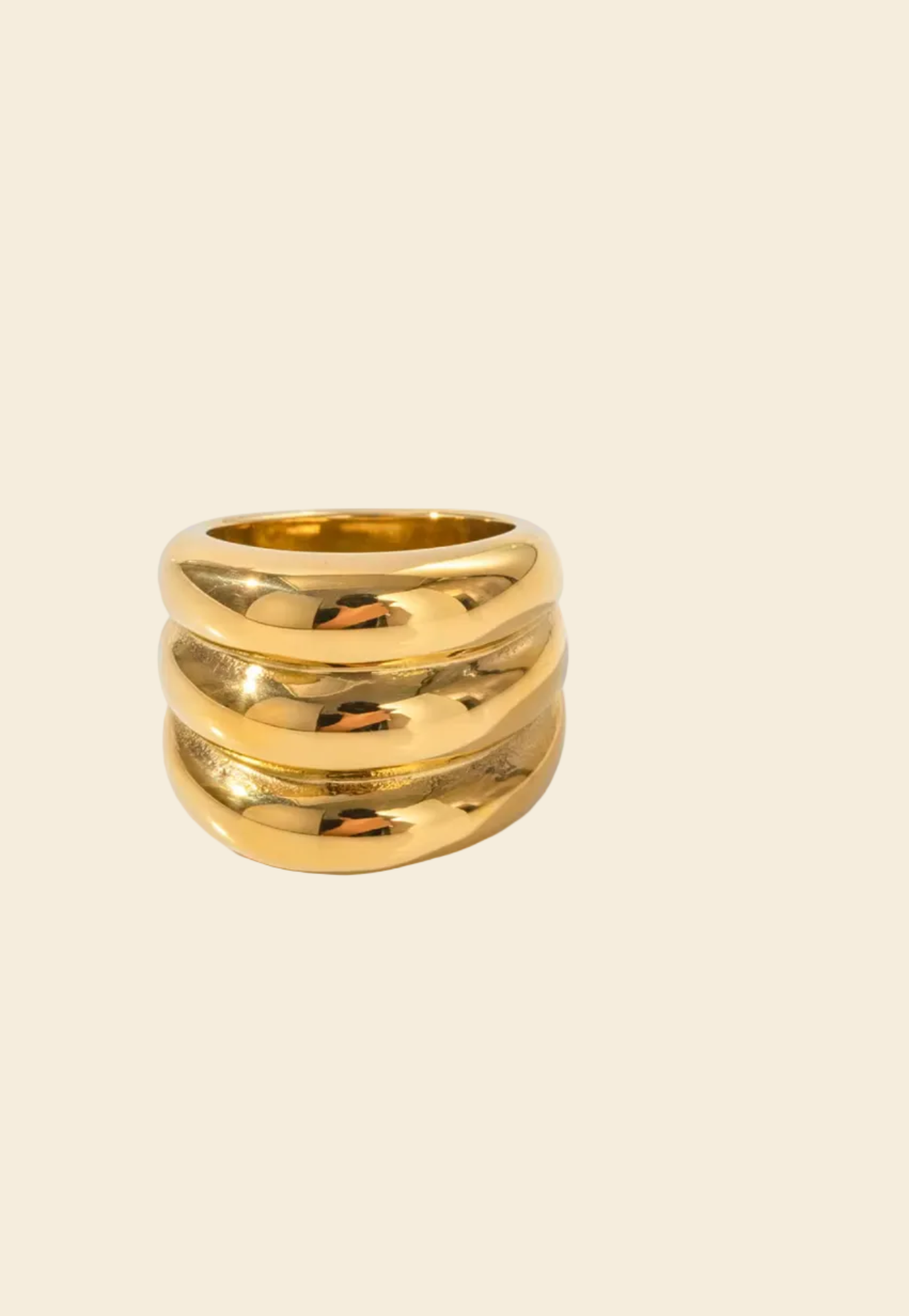 Gold ring with three bands on a white background