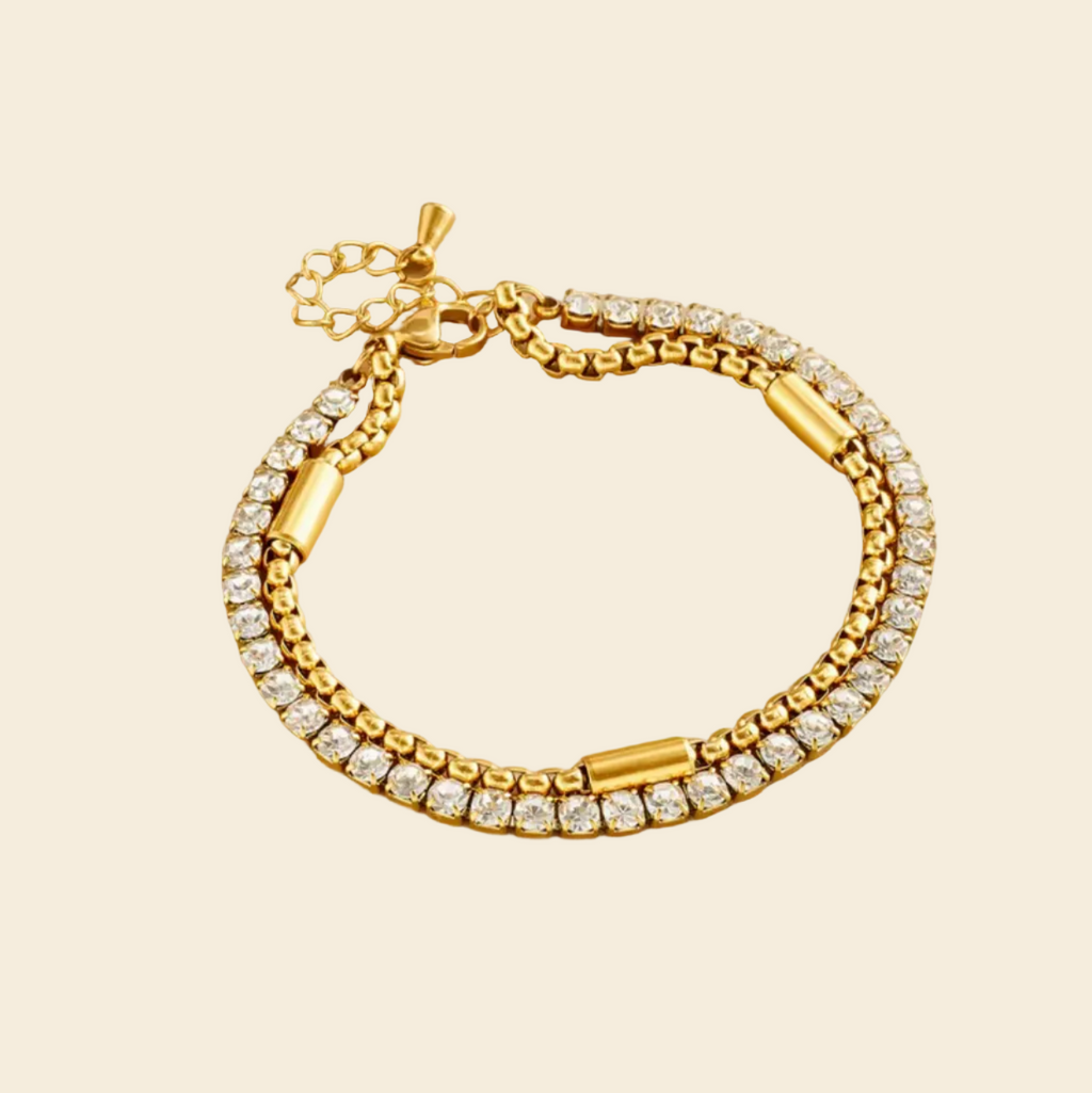 Gold bracelet on a beige box with 
