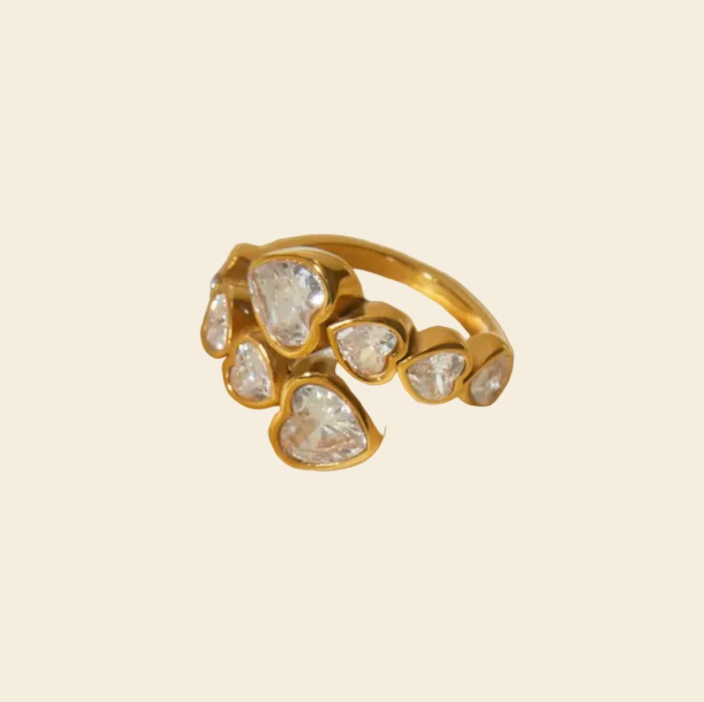 Gold ring with diamonds on a white fabric background