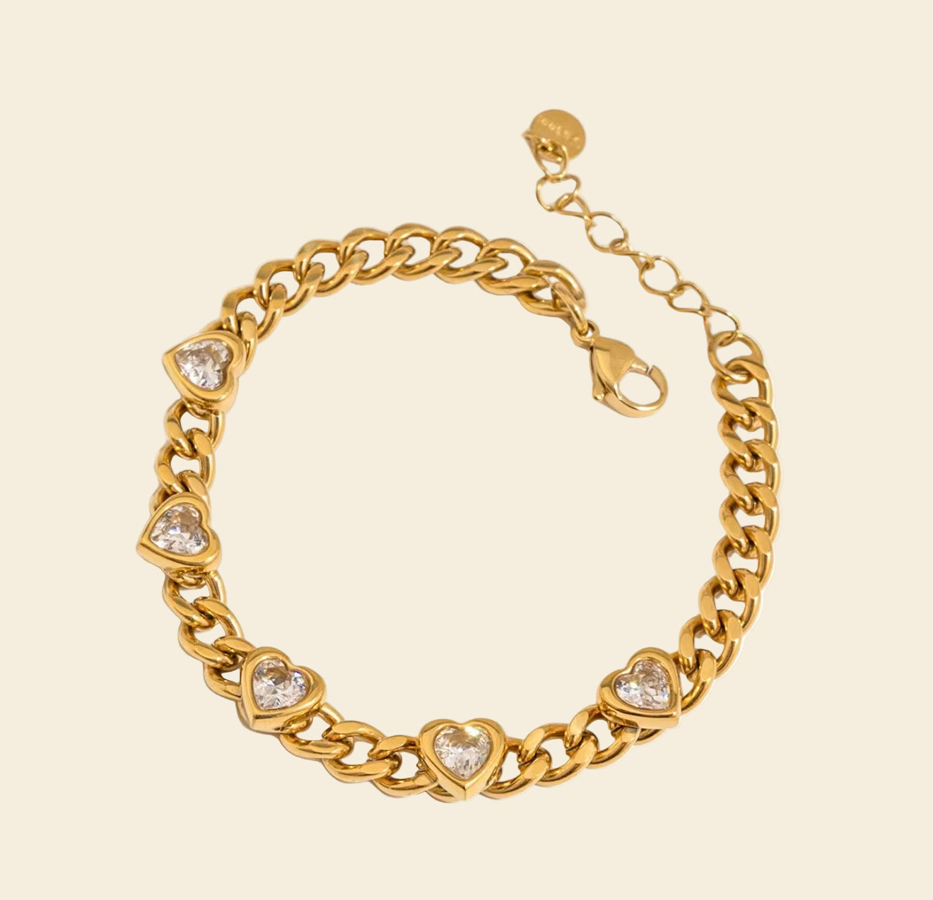 Gold bracelet with heart-shaped charms on a white background