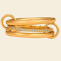 Gold stacked ring with diamond accents on a white background