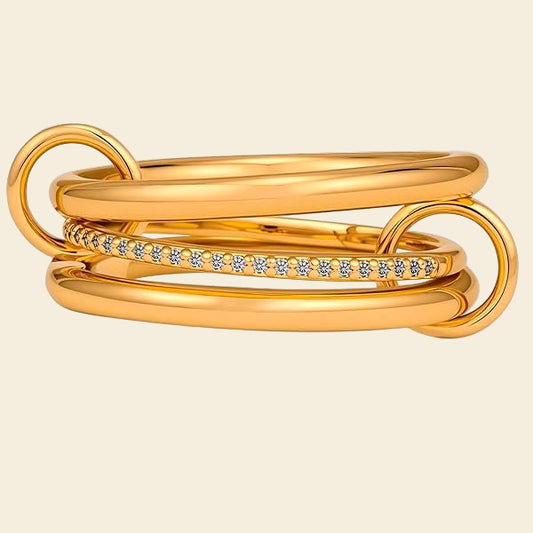 Gold stacked ring with diamond accents on a white background